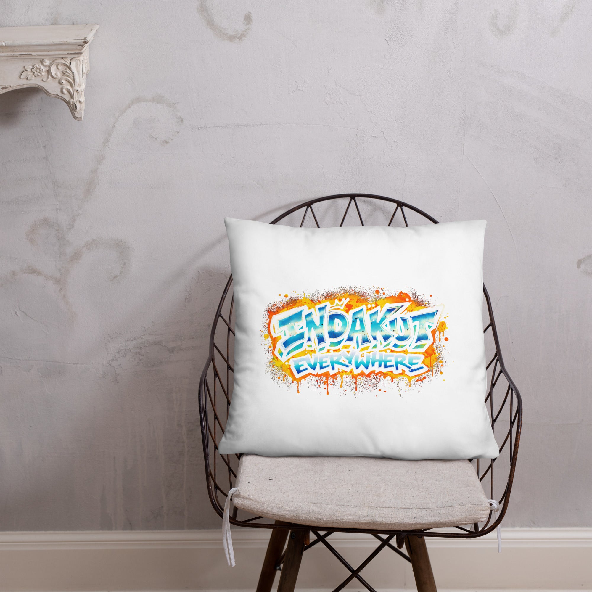 Indakut Everywhere throw pillow with graffiti logo design on chair in modern living room decor