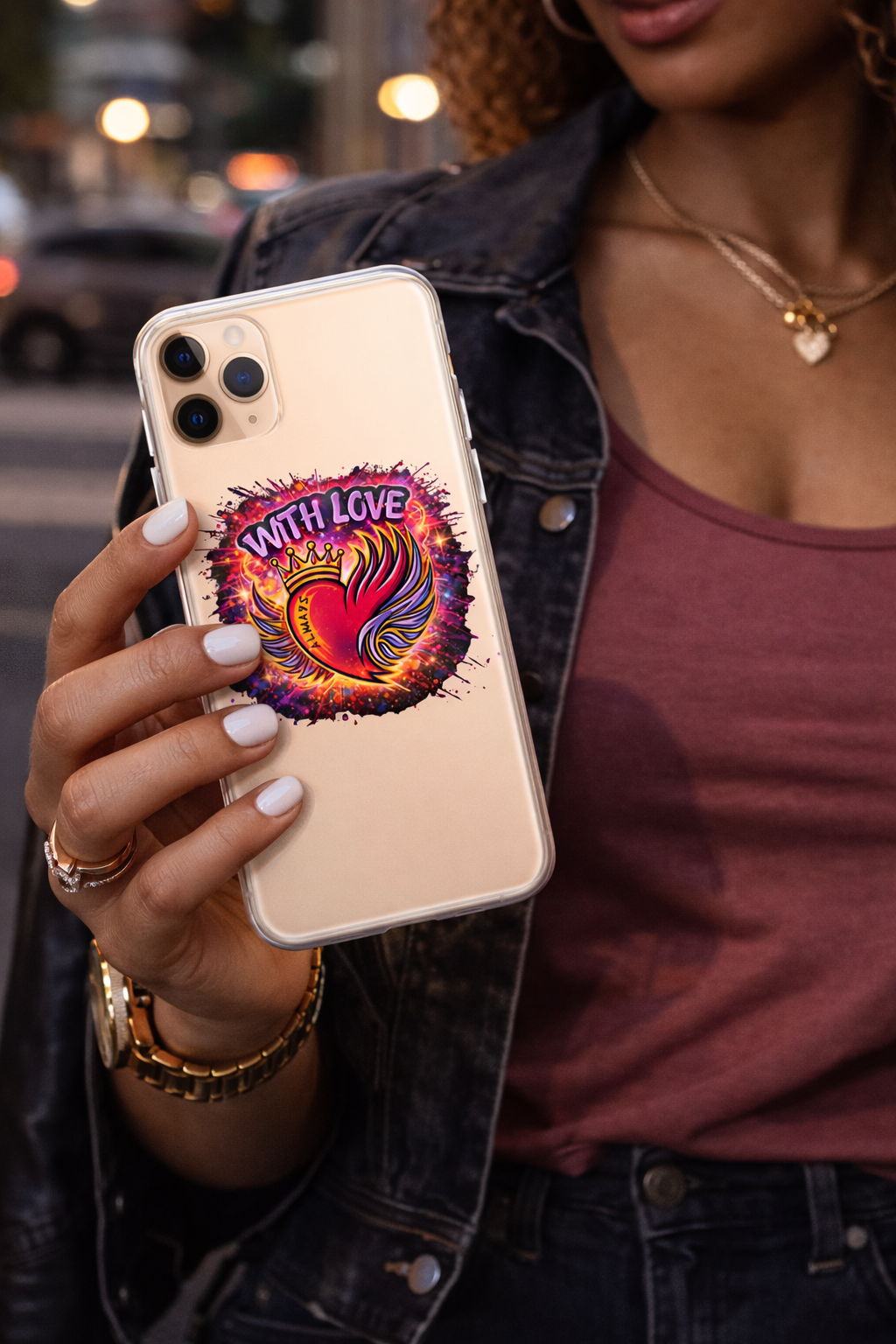 Woman holding With Love Always graphic iPhone case with heart and wings design in city setting